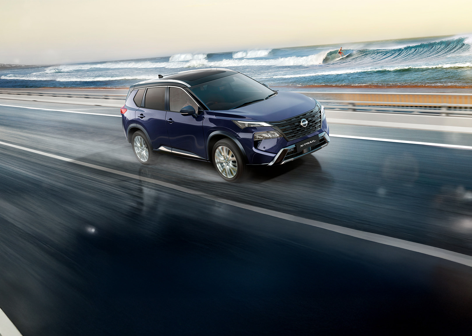 Blue Nissan X-TRAIL driving beside the coast
